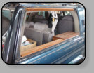 A very nice Chevrolet Suburban that received a poor workmanship new replacement quarter glass installation.